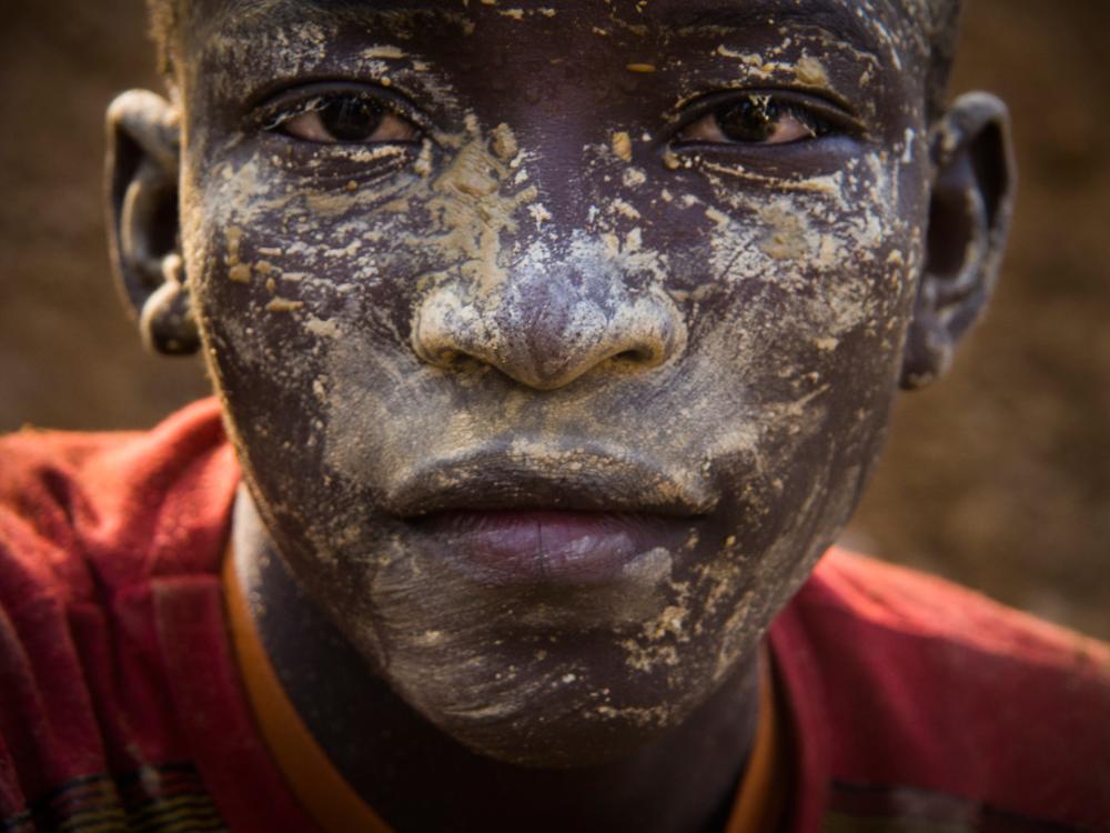 A young boy near the end of his shift at Fandjora. Image by Larry C. Price. Burkina Faso, 2013.