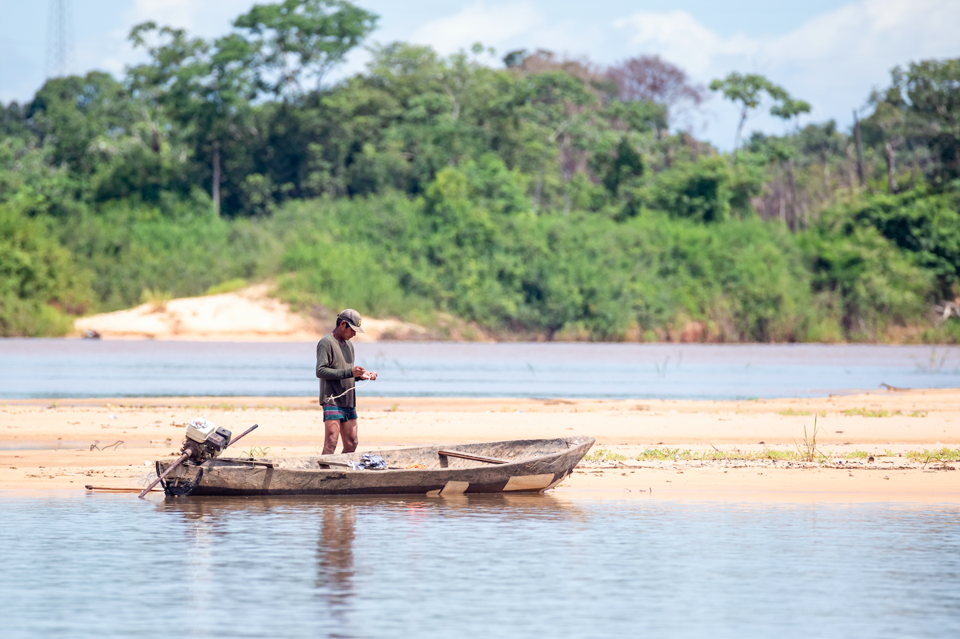 A man from a traditional Indigenous population preparing his boat and tools on the Araguaia river waters in Santa Terezinha, Mato Grosso. Image by JH Bispo/Shutterstock. Brazil, 2019. A man from a traditional Indigenous population preparing his boat and tools on the Araguaia river waters in Santa Terezinha, Mato Grosso. Image by JH Bispo/Shutterstock. Brazil, 2019.