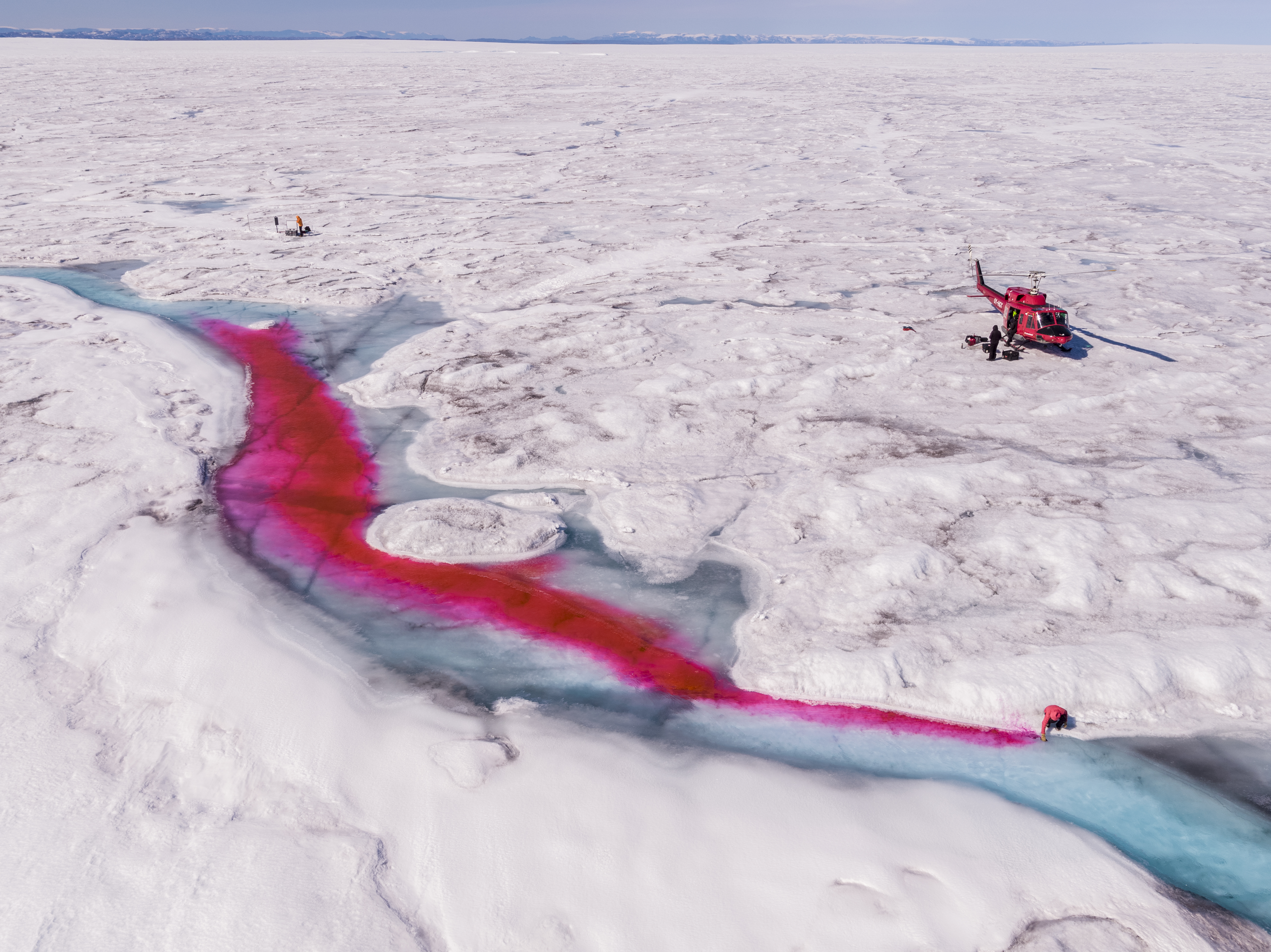 In March, Geophysical Research Letters reported that the western part of Greenland’s ice sheet is melting at its fastest rate in at least 450 years. Some scientists believe that the Arctic hasn’t seen ice melt like this in 5,000 years. If the ice sheet melts entirely, sea levels would rise 20 feet, leaving Lower Manhattan underwater. Jason Gulley, a geologist, and Celia Trunz, a Ph.D. student in geology, have been conducting meltwater research by releasing a fluorescent red dye to determine how and why more rivers form on the surface of the ice sheet and what will happen as a result of these new and turbulent flows. So far, they have found that the rivers lubricate the ice slab, making the sheets move faster toward the coasts, which could cause even more icebergs to calve into the ocean. Image by George Steinmetz. Greenland, 2017. In March, Geophysical Research Letters reported that the western part of Greenland’s ice sheet is melting at its fastest rate in at least 450 years. Some scientists believe that the Arctic hasn’t seen ice melt like this in 5,000 years. If the ice sheet melts entirely, sea levels would rise 20 feet, leaving Lower Manhattan underwater. Jason Gulley, a geologist, and Celia Trunz, a Ph.D. student in geology, have been conducting meltwater research by releasing a fluorescent red dye to determine how and why…