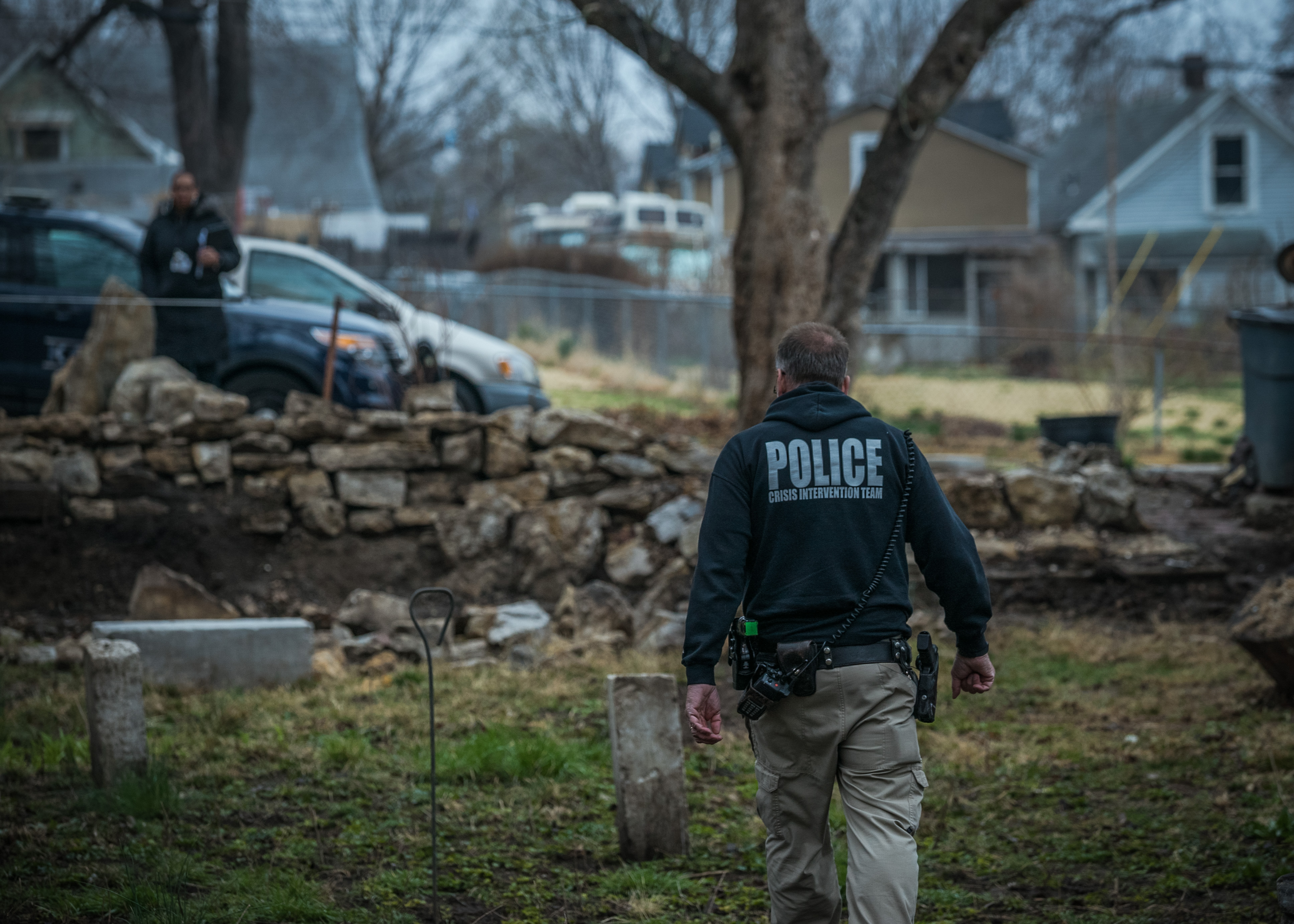 Kansas City, MO Police Officer Aric Anderson, who is part of the police crisis intervention team, looks for a homeless man with mental illness at an abandoned house he is known to stay at. Image by PBS Newshour. United States, 2018. Kansas City, MO Police Officer Aric Anderson, who is part of the police crisis intervention team, looks for a homeless man with mental illness at an abandoned house he is known to stay at. Image by PBS Newshour. United States, 2018.