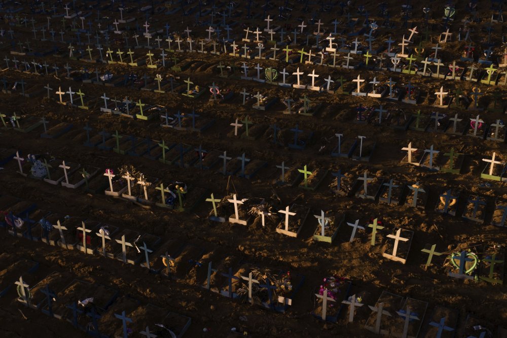 Crosses mark the graves of those who have passed away since early April, filling a new section of the Nossa Senhora Aparecida public cemetery amid the new coronavirus pandemic in Manaus, Brazil, Sunday, May 16, 2020. Image by Felipe Dana / AP Photo. Brazil, 2020. Crosses mark the graves of those who have passed away since early April, filling a new section of the Nossa Senhora Aparecida public cemetery amid the new coronavirus pandemic in Manaus, Brazil, Sunday, May 16, 2020. Image by Felipe Dana / AP Photo. Brazil, 2020.