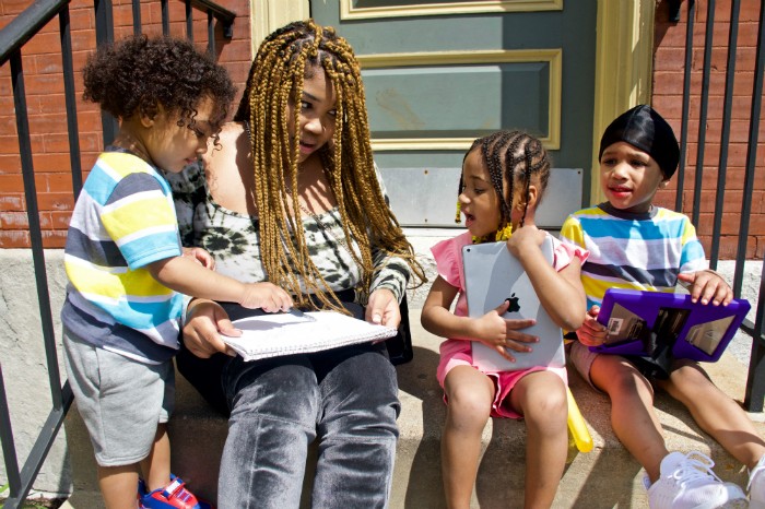Courtnesha Rogers with her children, (from left) Angelino, 2, Angele and Angelo, both 4. Rogers is eager for them to start school again, but wonders about the measures that will be taken to keep them safe. Image by Wiley Price/St. Louis American. United States, 2020. Courtnesha Rogers with her children, (from left) Angelino, 2, Angele and Angelo, both 4. Rogers is eager for them to start school again, but wonders about the measures that will be taken to keep them safe. Image by Wiley Price/St. Louis American. United States, 2020.