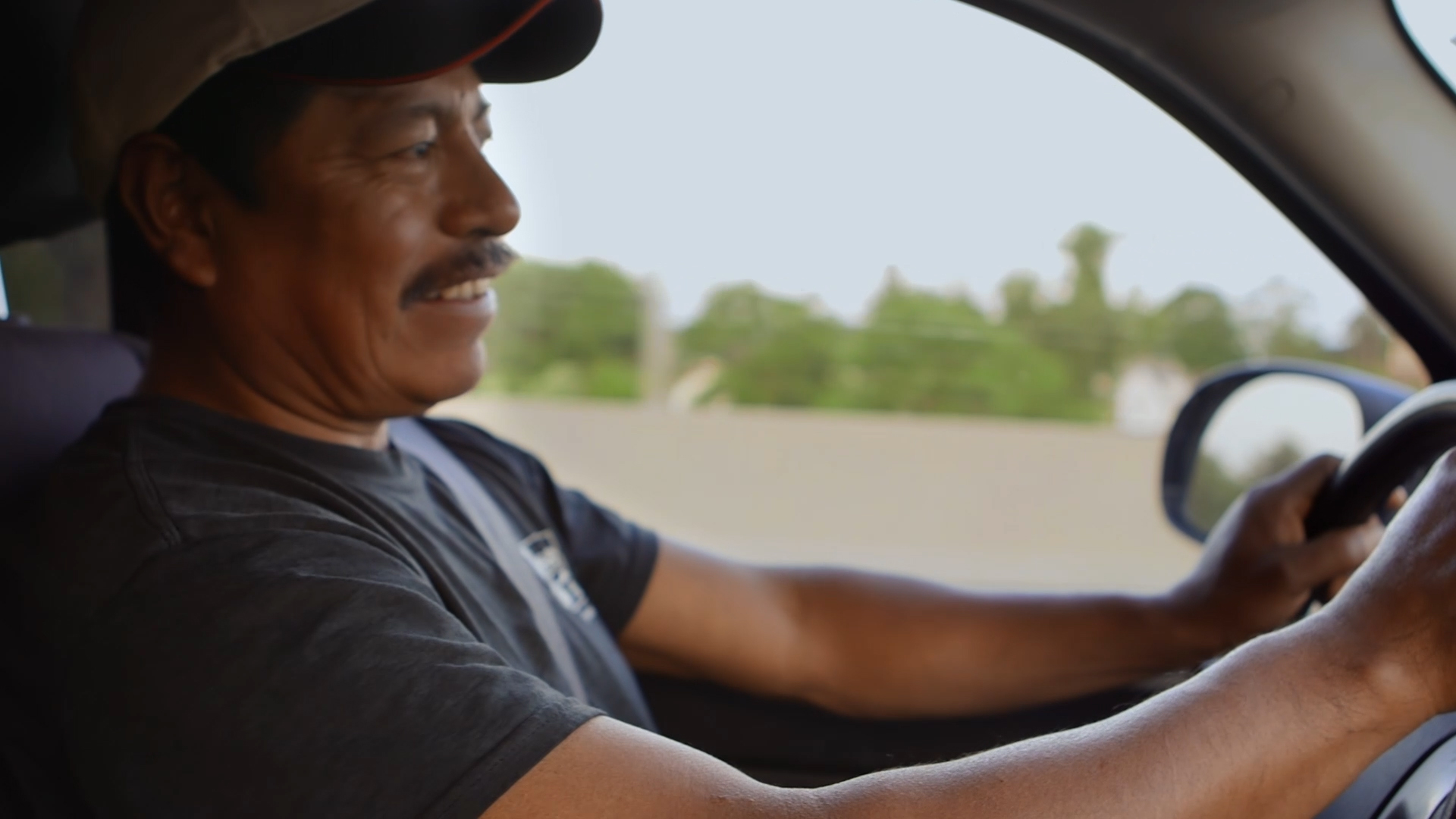Winny Contreras drives to the farm he lives and works on while reminiscing about his son's message on Father's day. Image by Sana Malik. United States, 2019. Winny Contreras drives to the farm he lives and works on while reminiscing about his son's message on Father's day. Image by Sana Malik. United States, 2019.