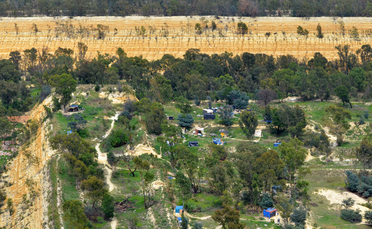 informal settlement An informal settlement near Johannesburg sits atop a pile of unrehabilitated gold mine waste. Image by Mark Olalde. South Africa, 2017.