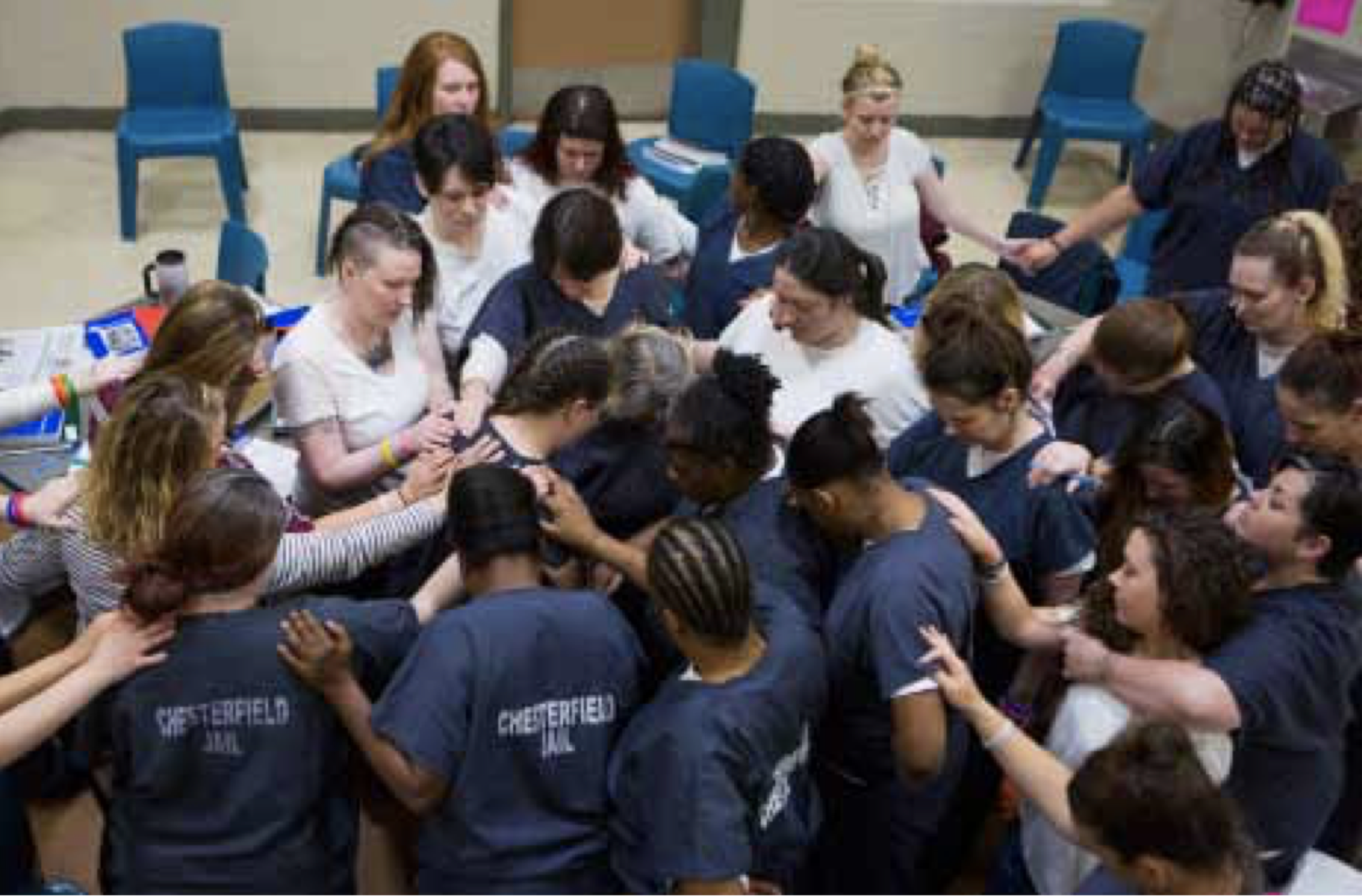 HARP participants — including Tera Crowder (far left middle, in white T-shirt) — prayed for a participant being released in November 2017. Image by United States, undated.