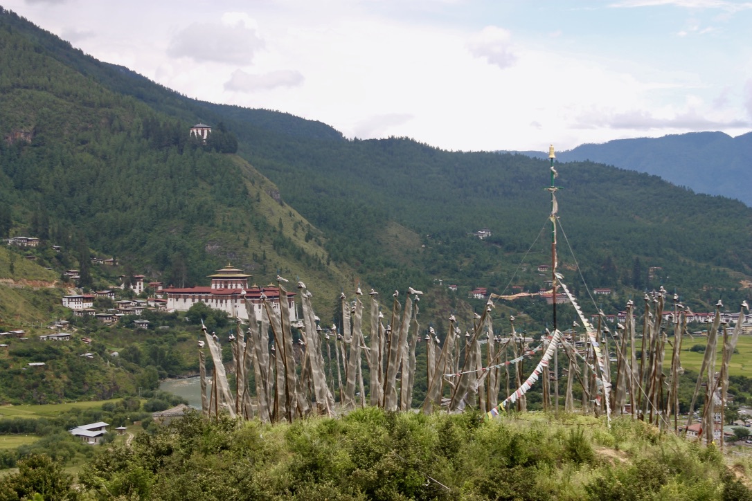 A view of prayer flags and the Paro dzong, or fortress, in Paro, Bhutan. Image by Emma Johnson. Bhutan, 2019. A view of prayer flags and the Paro dzong, or fortress, in Paro, Bhutan. Image by Emma Johnson. Bhutan, 2019.