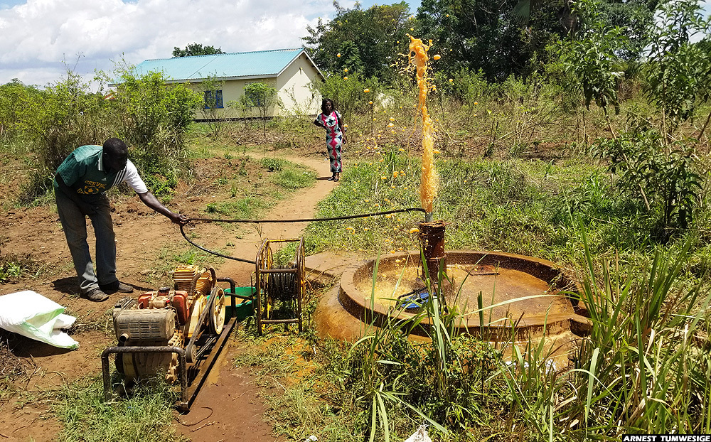 A water pump technician testing an abandoned borehole near a health facility in Lakwana sub-county, Omoro district. Image by Arnest Tumwesige. Uganda, 2020. A water pump technician testing an abandoned borehole near a health facility in Lakwana sub-county, Omoro district. Image by Arnest Tumwesige. Uganda, 2020.