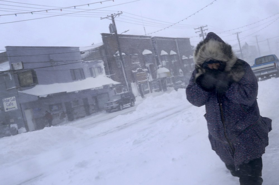 In this Feb. 23, 2019, photo, a woman shields her face from the wind during a snow storm as she walks on Front Street in Nome, Alaska. Image by Wong Maye-E. United States, 2019. In this Feb. 23, 2019, photo, a woman shields her face from the wind during a snow storm as she walks on Front Street in Nome, Alaska. Image by Wong Maye-E. United States, 2019.