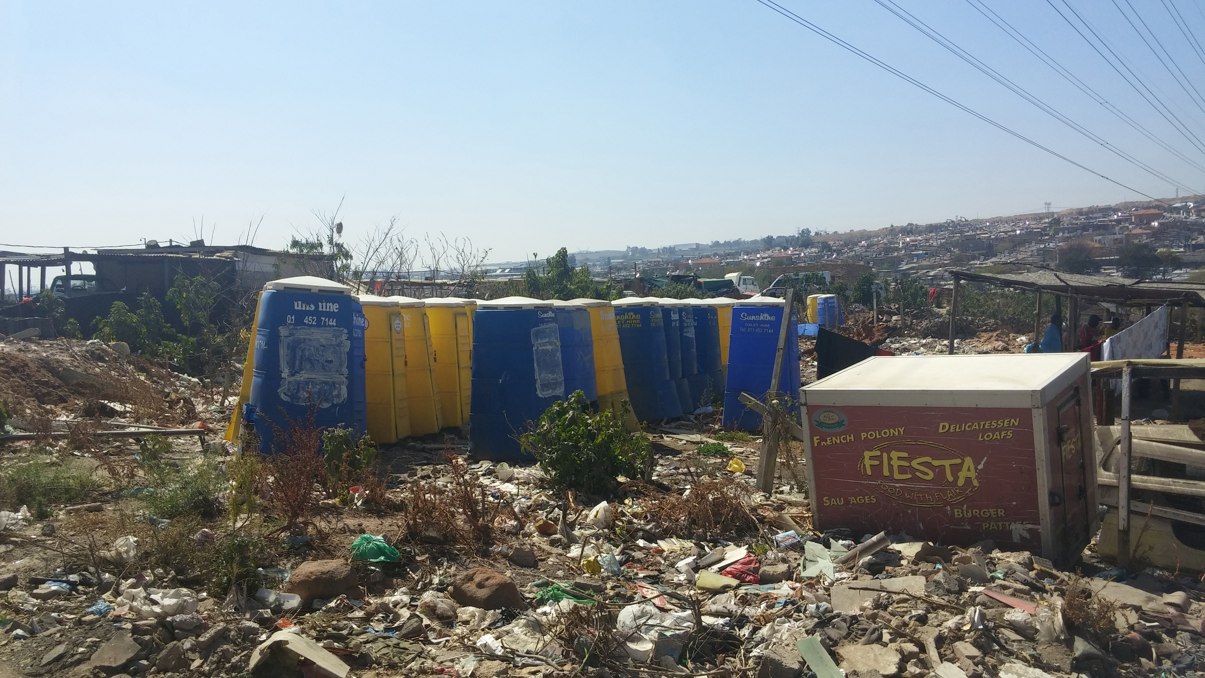 Trash piled up around Setswetla's chemical toilets. Image by Christian Belanger, South Africa, 2016. Trash piled up around Setswetla's chemical toilets. Image by Christian Belanger, South Africa, 2016.