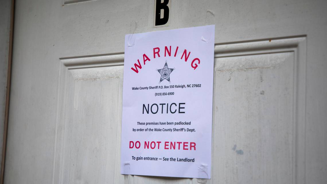 A padlock notice is taped to the door of an apartment, whose tenant was unavailable for comment, in late August in Raleigh, N.C. Image by Casey Toth. United States, 2020. A padlock notice is taped to the door of an apartment, whose tenant was unavailable for comment, in late August in Raleigh, N.C. Image by Casey Toth. United States, 2020.