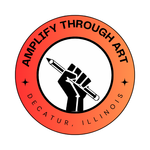 Amplify Through Art Logo Amplify Through Art Logo - black fist holding a pencil framed by an orange gradient circle with the text "Amplify Through Art, Decatur, Illinois"
