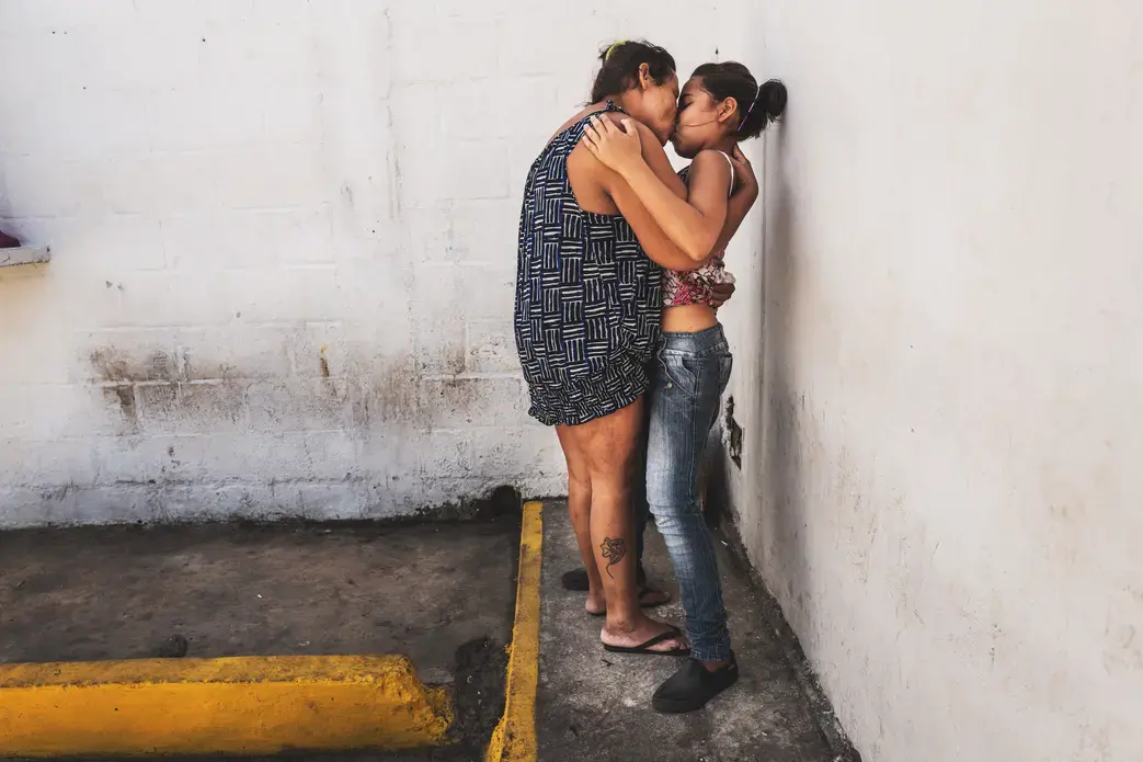 POLI-VALENCIA, CARABOBO - March 2018. Maria (on the left) kisses her daughter on visitation hours. She is 35 years old and is charged with robbery. She goes to therapy three times a week. While the beginning of the trials keep on being delayed, the condition of these women inside this precinct in the center of Valencia, a city on north-center of the country, has improved slightly between 2017 and 2018. They are now permitted to have a cellphone, hairdressing utensils and a 3hour recreation time outside…