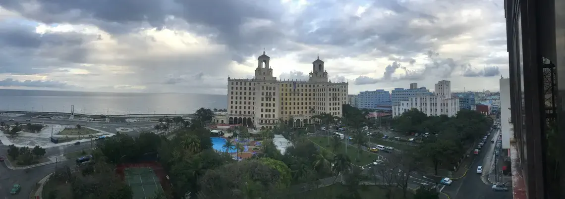Three aspects of Havana's skyline meet on a cloudy day: the Malecón, Vedado, and Havana Vieja. Image by Esohe Osabuohien. Cuba, 2018.