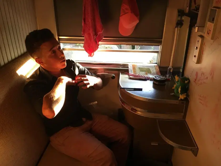 Moayad Alsaour lived in an abandoned sleeper car in Idomeni refugee camp in northern Greece. Image by Jeanne Carstensen. Greece, 2016.