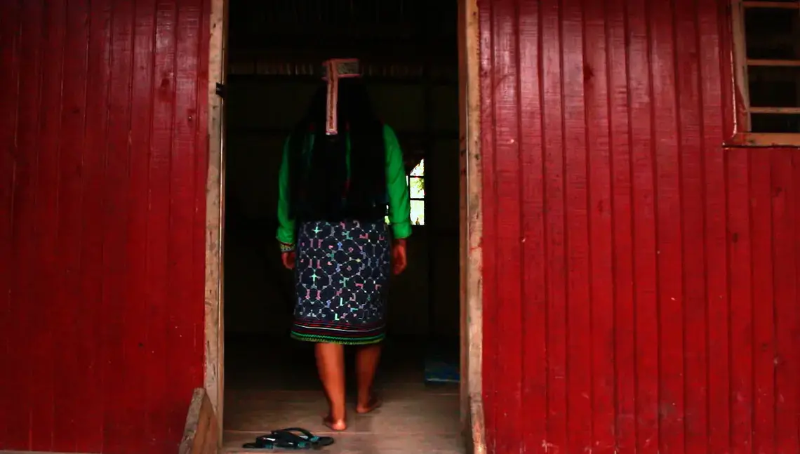 Karina Garcia&nbsp;Ríos, who calls herself 'Mujer Medicina,' or medicine woman, walks into the ceremonial room in her home in Pucallpa.&nbsp;Image by Natalie Hutchison. Peru, 2017.