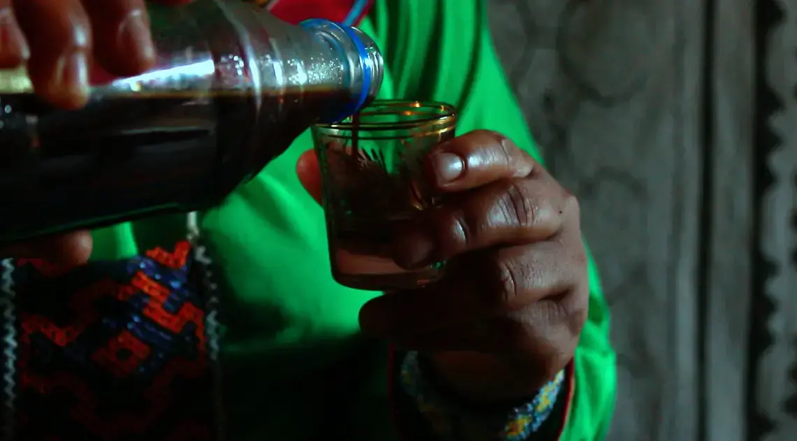Karina Garcia&nbsp;Ríos, the only female shaman in her community, serves Ayahuasca-a traditional medicinal beverage made from a serprent-shaped vine-during a healing ceremony.&nbsp;Image by Natalie Hutchison. Peru, 2017.