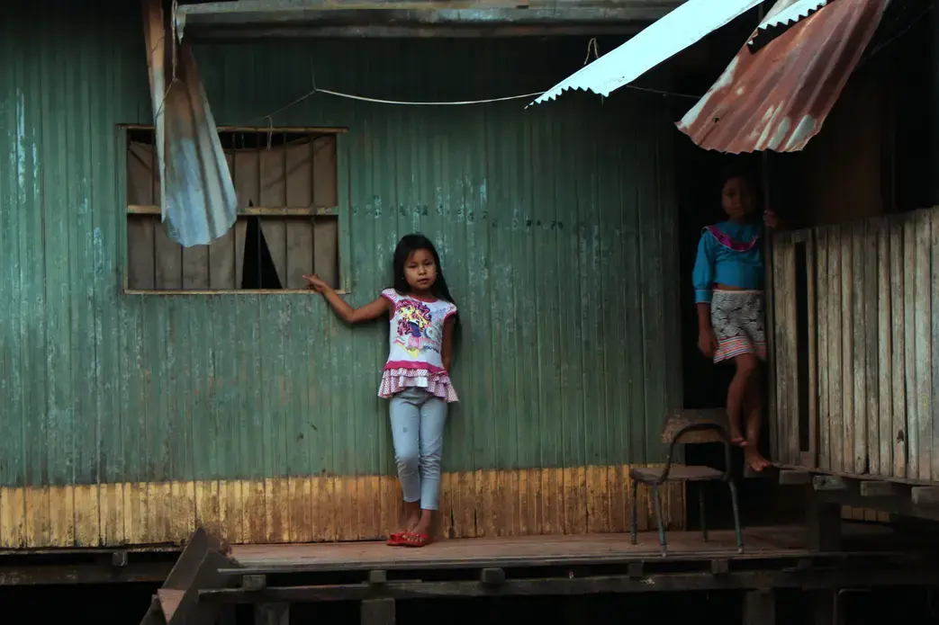 Karina's nieces, Angi and Sophia, in their home where the city meets the jungle in Pucallpa.&nbsp;Image by Natalie Hutchison. Peru, 2017.
