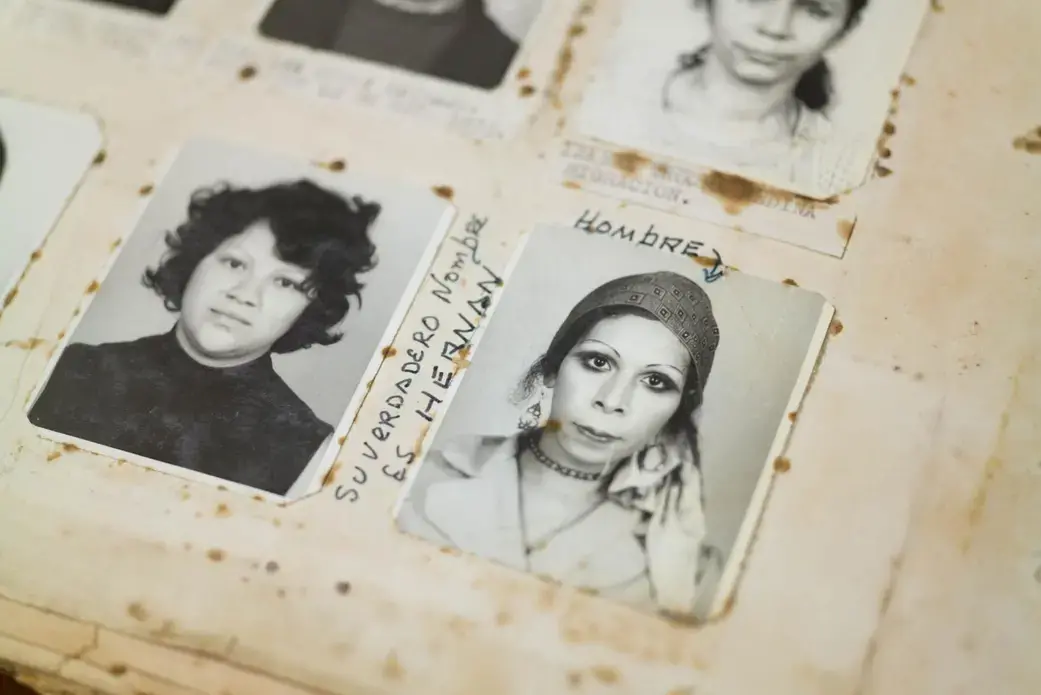 A photograph of a transgender woman detained in December 1973 by the National Police. The handwritten notes around the photograph translate to “is a man” and “his real name is Hernan.” Image by Lynn Johnson. Guatemala, 2017.