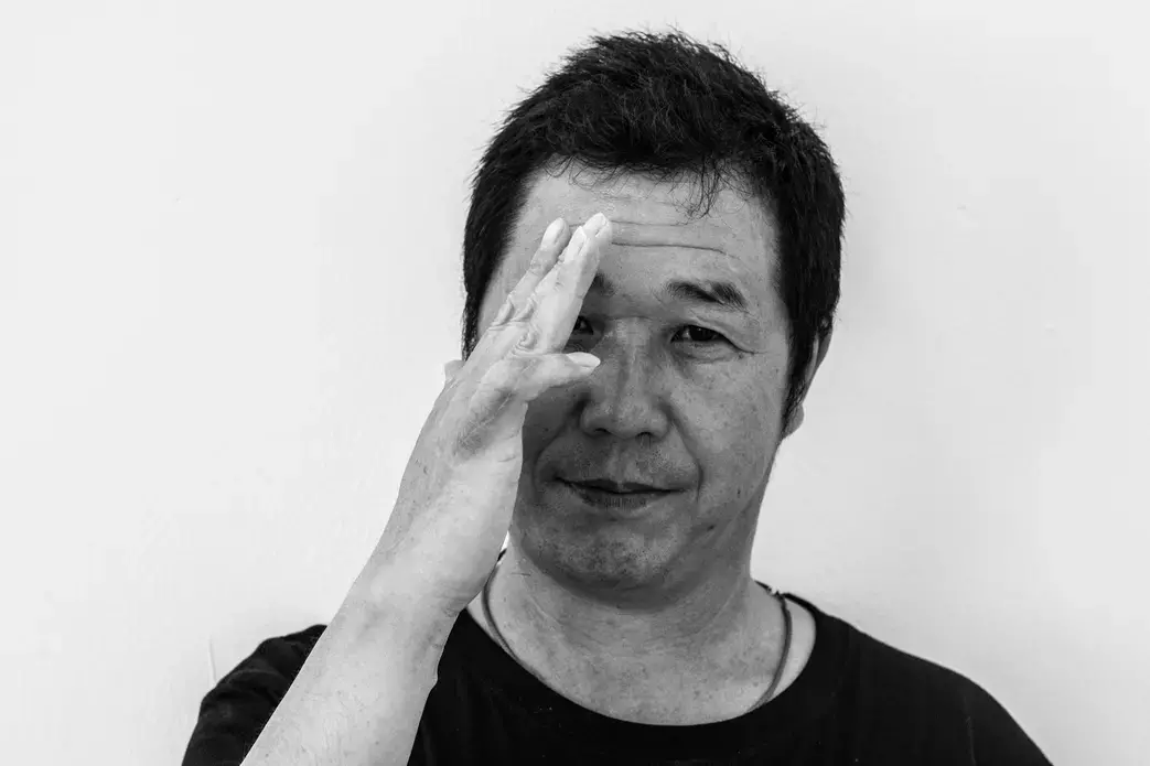 Zhang Yong Cheng, a 47 year-old butcher from China, shows his finger that was cut with a blade. His employer misreported this case when he was injured at work, and he was also underpaid, he said. Image by Xyza Bacani. Singapore, 2017.