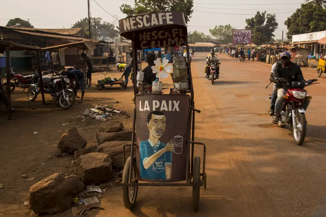 A coffee cart in Bangui, one of many wheeled around the bustling, dusty capital city. The front reads "La Paix" - "Peace". Image by Jack Losh. Central African Republic, 2018.
