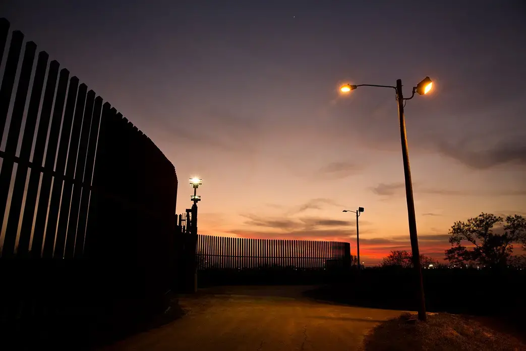 The border fence and levee pass through the Lower Rio Grande Valley National Wildlife Refuge in Hidalgo. Image by Callie Richmond. United States, 2017.