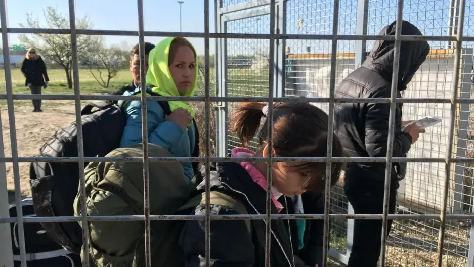 An Afghan refugee family enters Hungary from Serbia.  Under a controversial new Hungarian border law, they live in a detention camp at the border until their case is decided. Image by Jeanne Carstensen. Hungary, 2017.