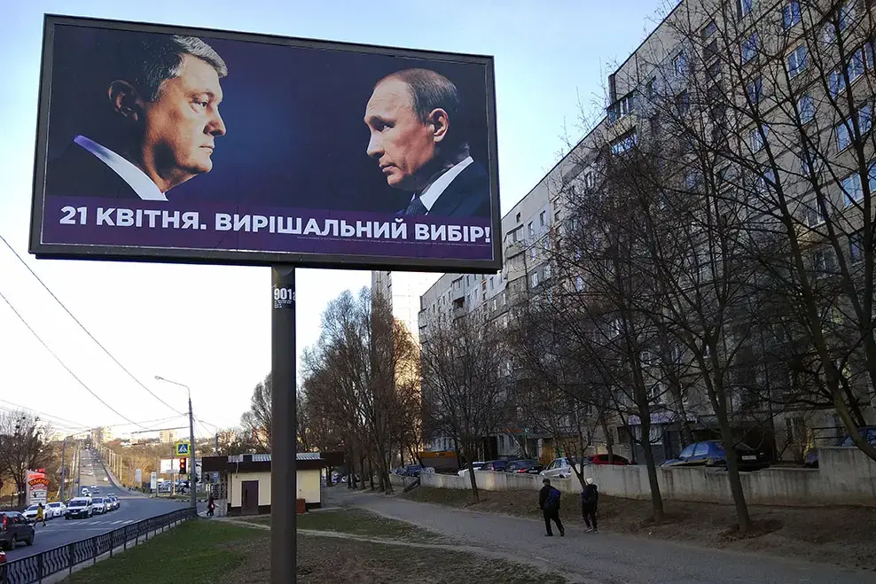 Billboard with portraits of Ukrainian President Petro Poroshenko and Russian president Vladimir Putin, ahead of the second round of 2019 Ukraine Presidential Election. Image by Aquatarkus / Shutterstock.com. Ukraine, 2019.