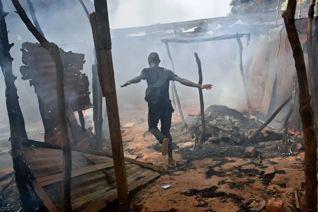 A neighborhood in the capital, Bangui, smolders in 2014 after Christian-led militias attacked predominantly Muslim rebels who had ousted the government. The faiths once coexisted in relative peace, but chaos has reigned in much of the nation for the past four years. Image by Marcus Bleasdale. Central African Republic.