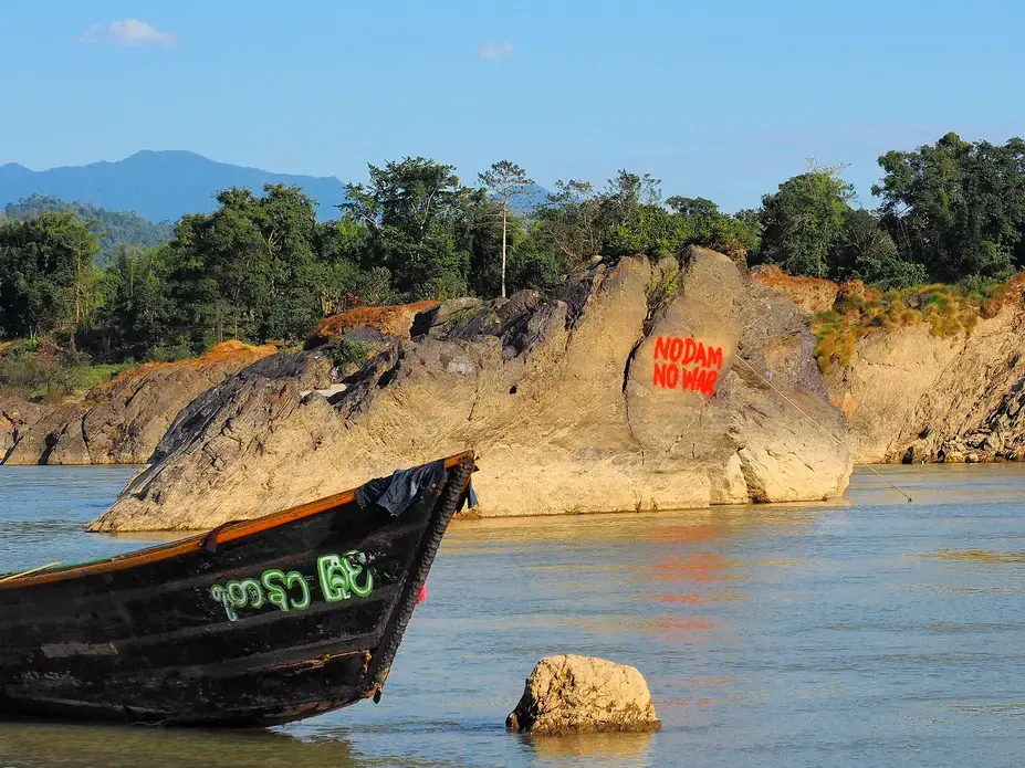 Graffiti near the Myitsone Dam, expressing popular Kachin sentiments about the root causes of the ongoing civil war. Image by Doug Bock Clark. Myanmar, 2017.