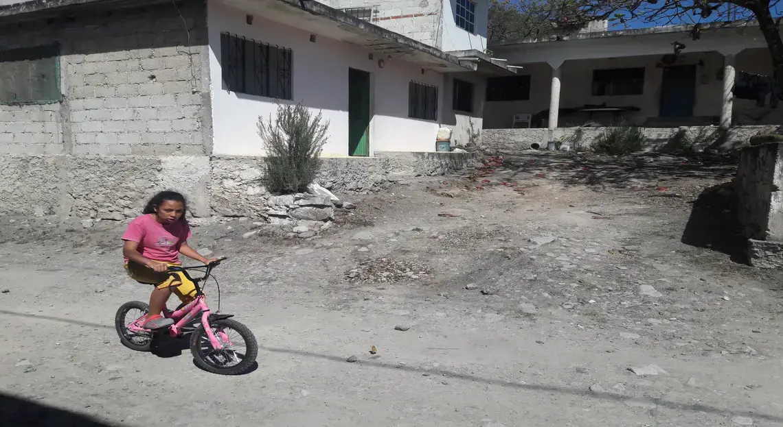 A young girl rides her bike through Coyolillo, a small town in Veracruz with a high population of Afro-Mexicans. Image by Jonathan Custodio. Mexico, 2018.