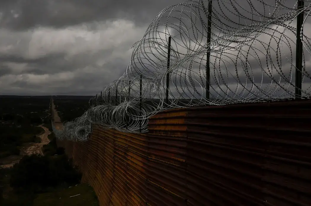 Personal items are left in the desert near the United States-Mexico border wall in Tecate, Mexico. This area is known to be a location for smugglers to bring people into the U.S. Image by Erika Schultz. Mexico, 2019.