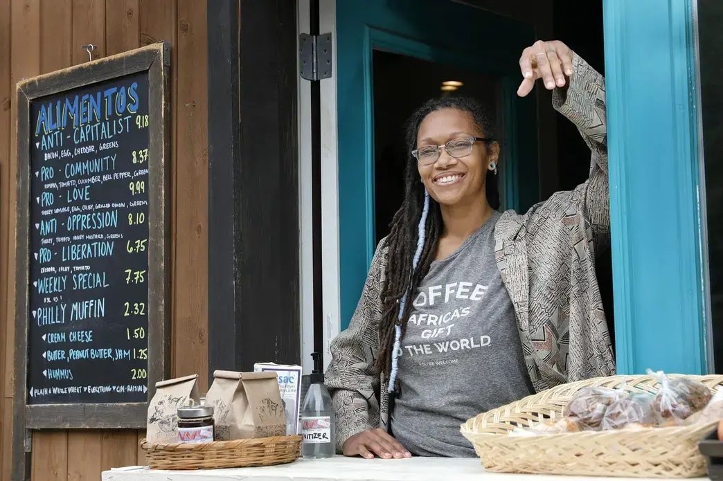 Blew Kind, owner of Franny Lou’s Porch Cafe &amp; Community Space, 2400 Coral St., Phila. Pa., was photographed at the cafe’s take out window on May 8, 2020. Image by Elizabeth Robertson / The Philadelphia Inquirer. United States, 2020.