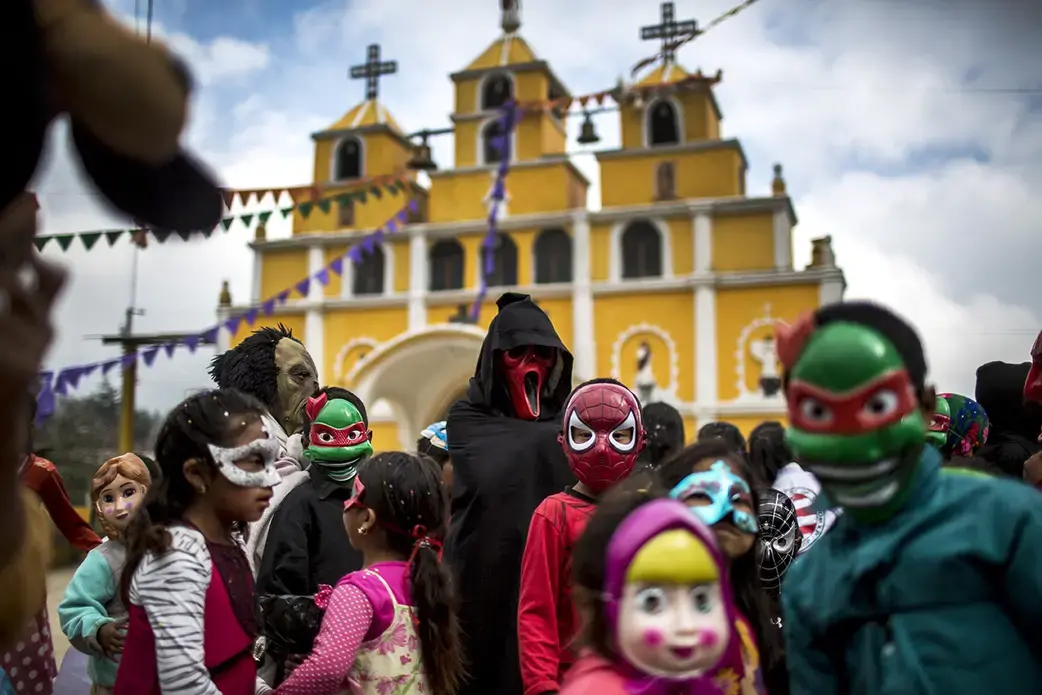 Primary school students from Bulej celebrate the carnival on March 5, in front of the church of San Mateo Apóstol. Image by Simone Dalmasso. Guatemala , 2019