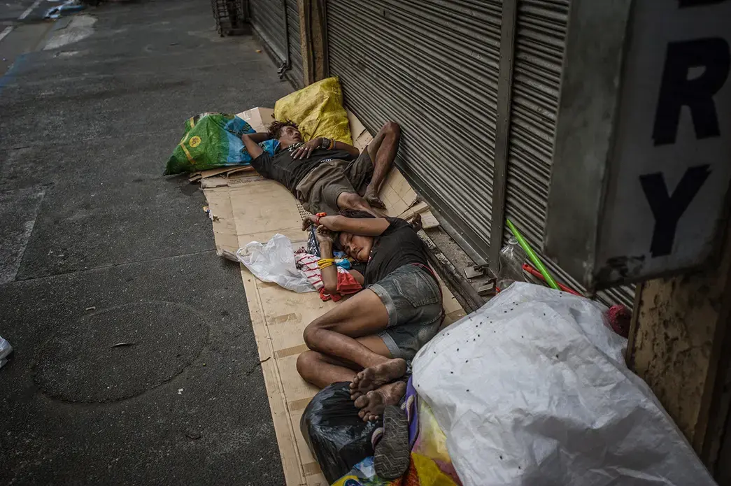 Many families sleep on Mabini Street of Malate, Manila, often suffering not only from poverty but substance abuse problems. By May 2016, a little over one month before the inauguration of Philippine President Rodrigo Duterte, extrajudicial killings have taken the lives of over 8,000 Filipinos. As of June 2017, almost all the homeless who sleep on Mabini Street are no longer there, their whereabouts unknown. Image by James Whitlow Delano. Philippines, 2016.