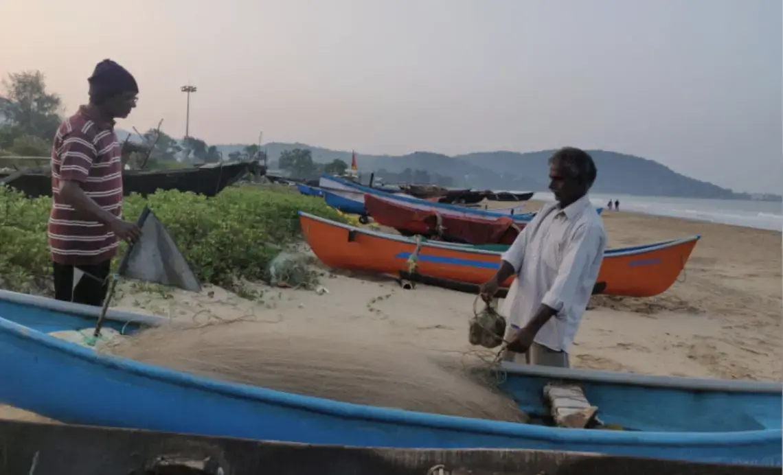 Sadanand Malshekar (right), 62, is among the thousands of fisherfolk who are worried that the Karwar port’s expansion will pollute the water in the fishing harbour and damage the beach they use to anchor their boats. Image by Disha Shetty / IndiaSpend. India, 2020.