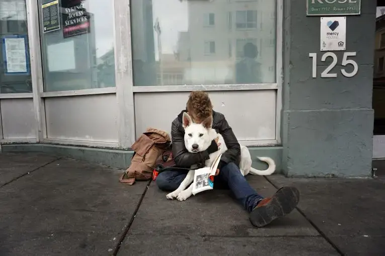 An image taken by an ex-inmate as part of Brian Frank's "Visions of Justice" project. The image captures a young man and his dog on the streets of San Francisco. Image by Chris Shurn. United States, 2018.