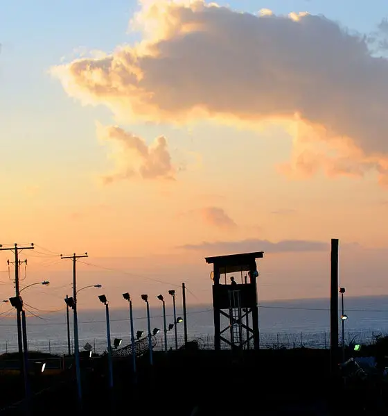 A watchtower at the Guantanamo Bay prison camp, at dusk. Image courtesy of Wikimedia Commons. Cuba, 2011.