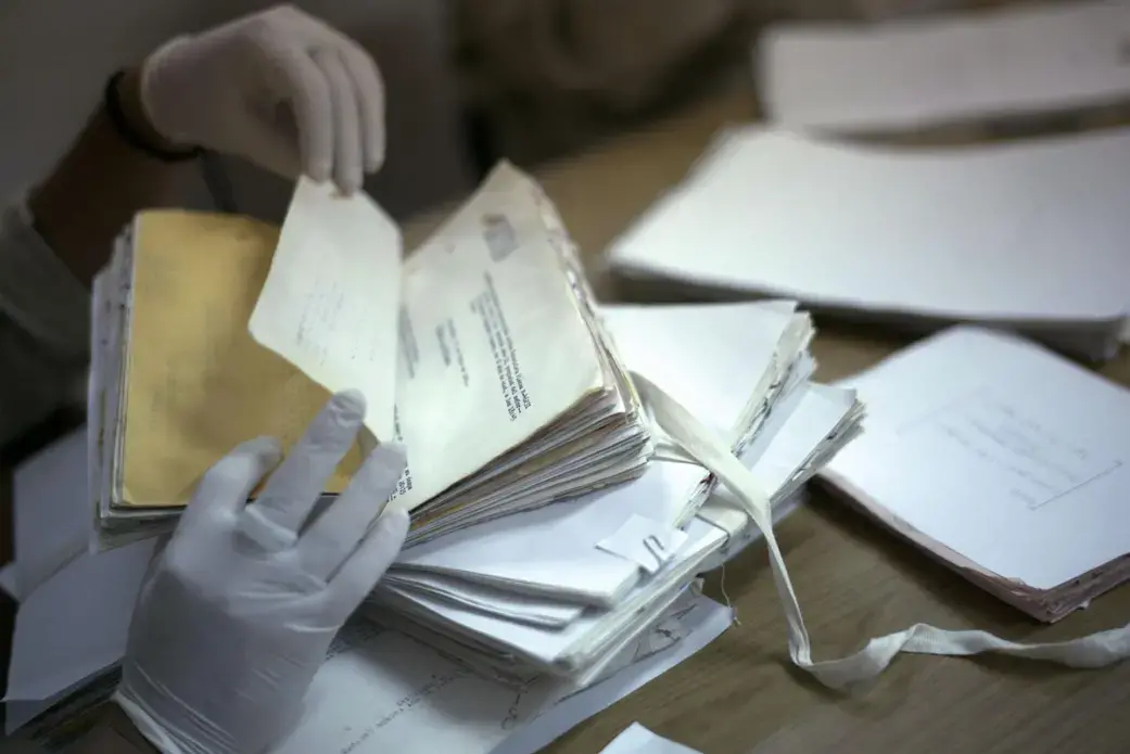 Each of the archive’s estimated 80 million pages must be cleaned, read, and categorized by a trained archivist before it is digitized. As they work, the archivists are uncovering not only thousands of names and faces but also the institutional structure of the National Police, gradually exposing how the organization carried out its deadly work. Image by Lynn Johnson. Guatemala, 2017.