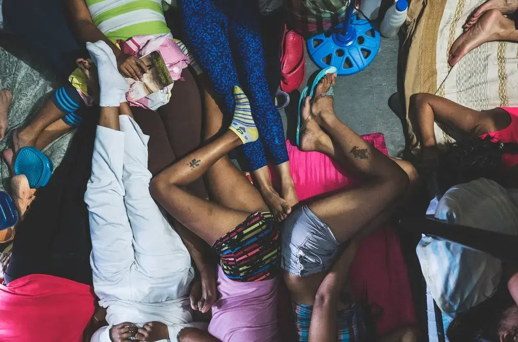 Twenty-two female detainees await trial for months or even years at La Yaguara Detention Center. They are packed into a 9-by-12-foot cell where most sleep on mattresses on the floor. Image by Ana María Arévalo. Venezuela, 2018. 