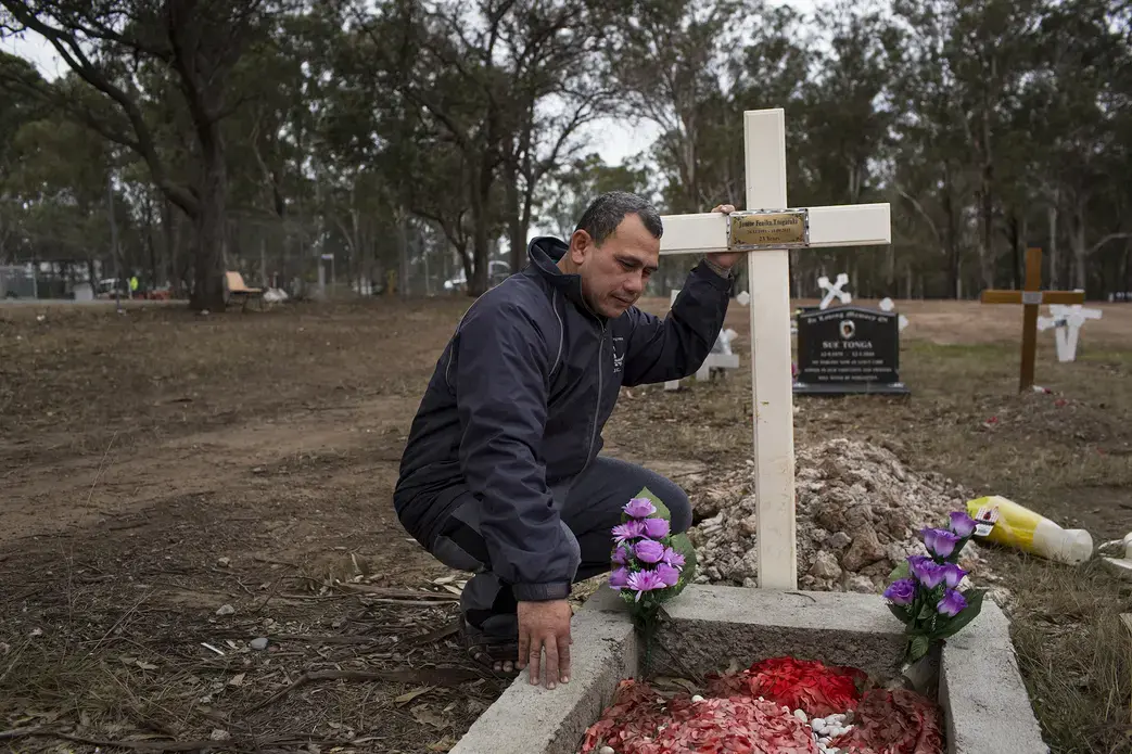 Vaea Togatuki, 48, visits the grave of his son, Junior, who died by suicide on September 11, 2015 while incarcerated in Goulburn’s Correctional Center. Image by David Maurice Smith for The New York Times. Australia, 2018.