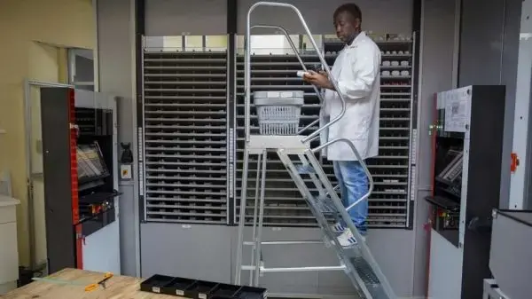 Pharmacy staffer scans pill bottles