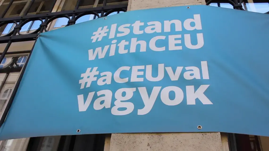 A banner reads "Hashtag: I Stand With CEU," referencing many students' wish to stay in Budapest.