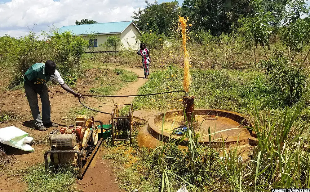 A water pump technician testing an abandoned borehole near a health facility in Lakwana sub-county, Omoro district. Image by Arnest Tumwesige. Uganda, 2020.