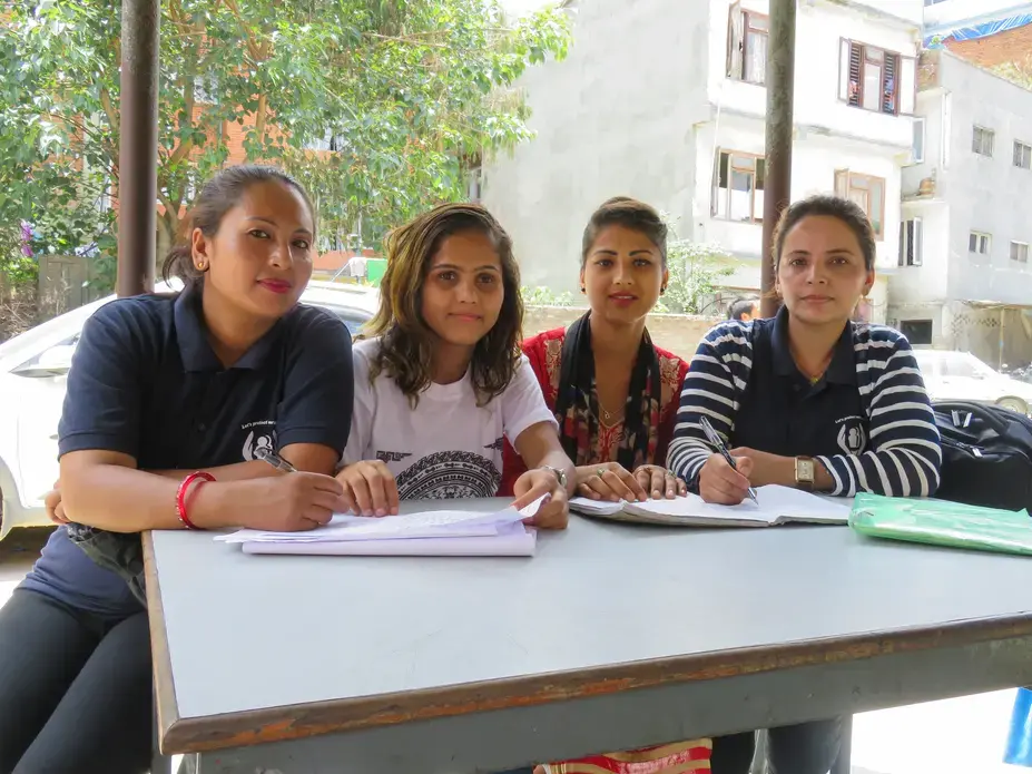 Survivors and certified paralegals Renuka, Bidhya, Apsara, and Santa work in a Kathmandu police station filing criminal complaints. Image by Nicole Brigstock. Nepal, 2018. 