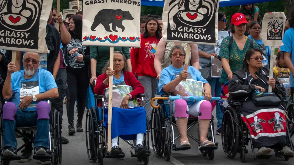 A group of elders help to lead the Grassy Narrows community march through Toronto. Image by Shelby Gilson. Canada, 2019.
