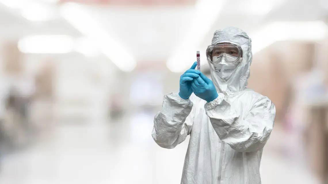 A lab technician scientist in PPE. Image by Chinnapong / Shutterstock.
