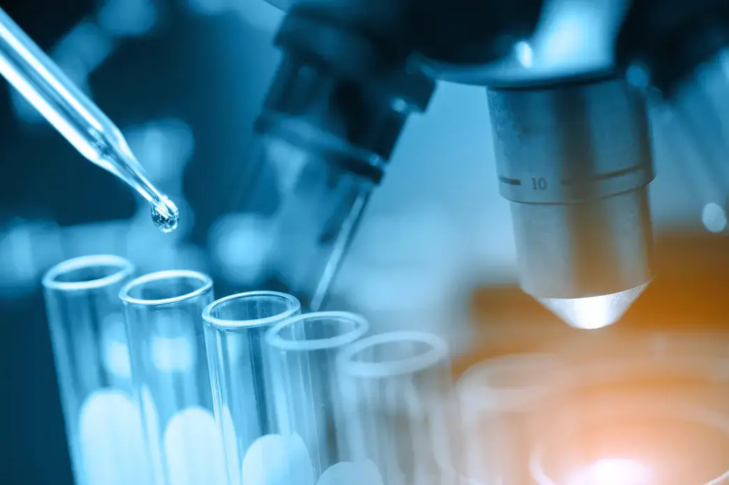 Microscope with lab glassware, science laboratory research, and development concept. Image by totojang1977/Shutterstock. Undated.