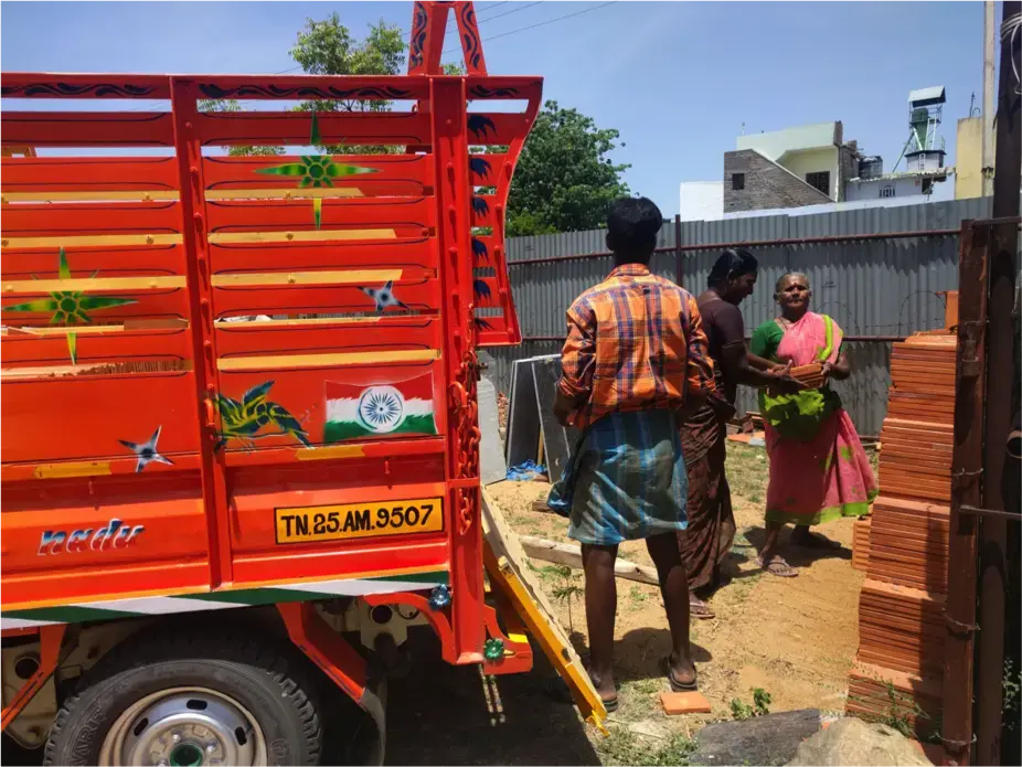 Workers at Shakthi Ganga lift materials into a lorry. The man will be paid 320 rupees, while the women will be paid 160 rupees each.&nbsp;Image by Praveena Somasundaram. India, 2017.