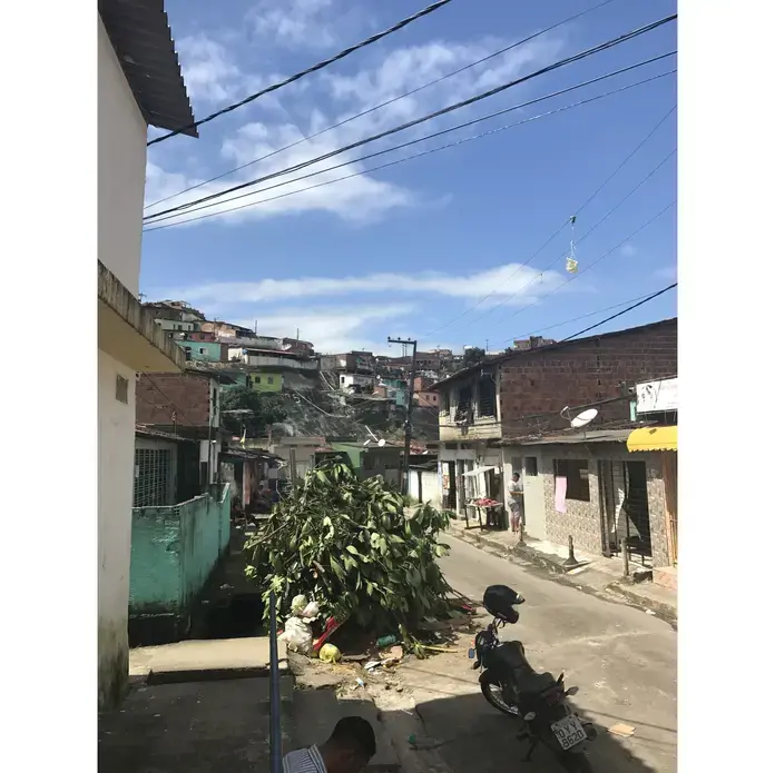 Outside the USF&nbsp;sits a mound of trash, which residents who live in the higher parts of the hills collect and bring down for disposal. Heavy rains, which are frequent in the winter months, spread the trash across the streets. Image by Poonam Daryani. Brazil, 2017.