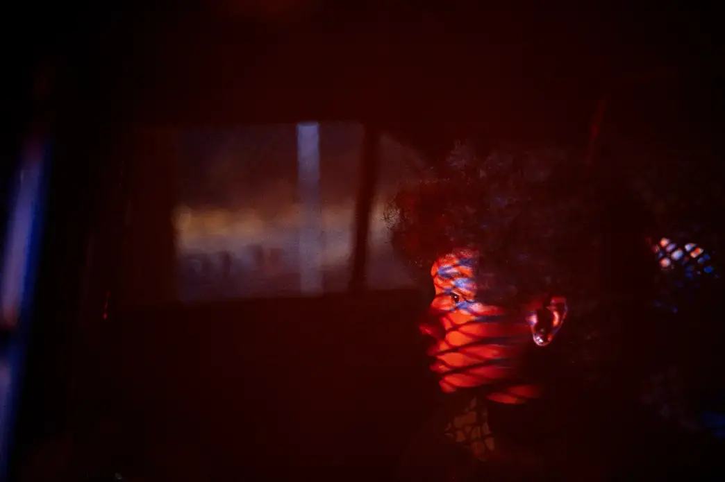 After leading the gang unit on a high speed car chase, a boy sits in custody while members of the unit chase his friends on foot through the neighborhood.  No weapons or drugs were found on any of the boys and after investigating, none were members of a gang and they ran because they were afraid of police. Image by Brian L. Frank/2017 Catchlight Fellow. United States, 2018.